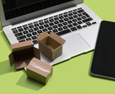 Stack of cardboard boxes on a laptop computer